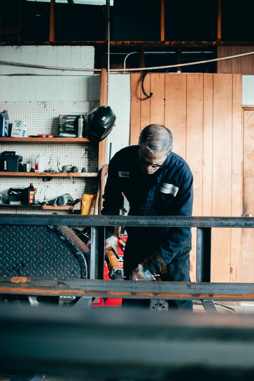 Metalworker grinding steel in his shop